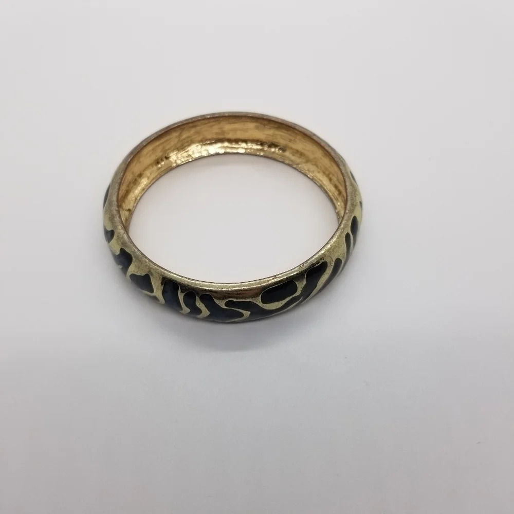 gold tone bangle with abstract black enamel pattern